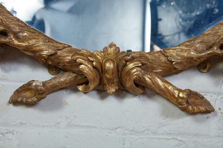 ROCOCO CARVED OVAL LOOKING GLASS, circa 1755