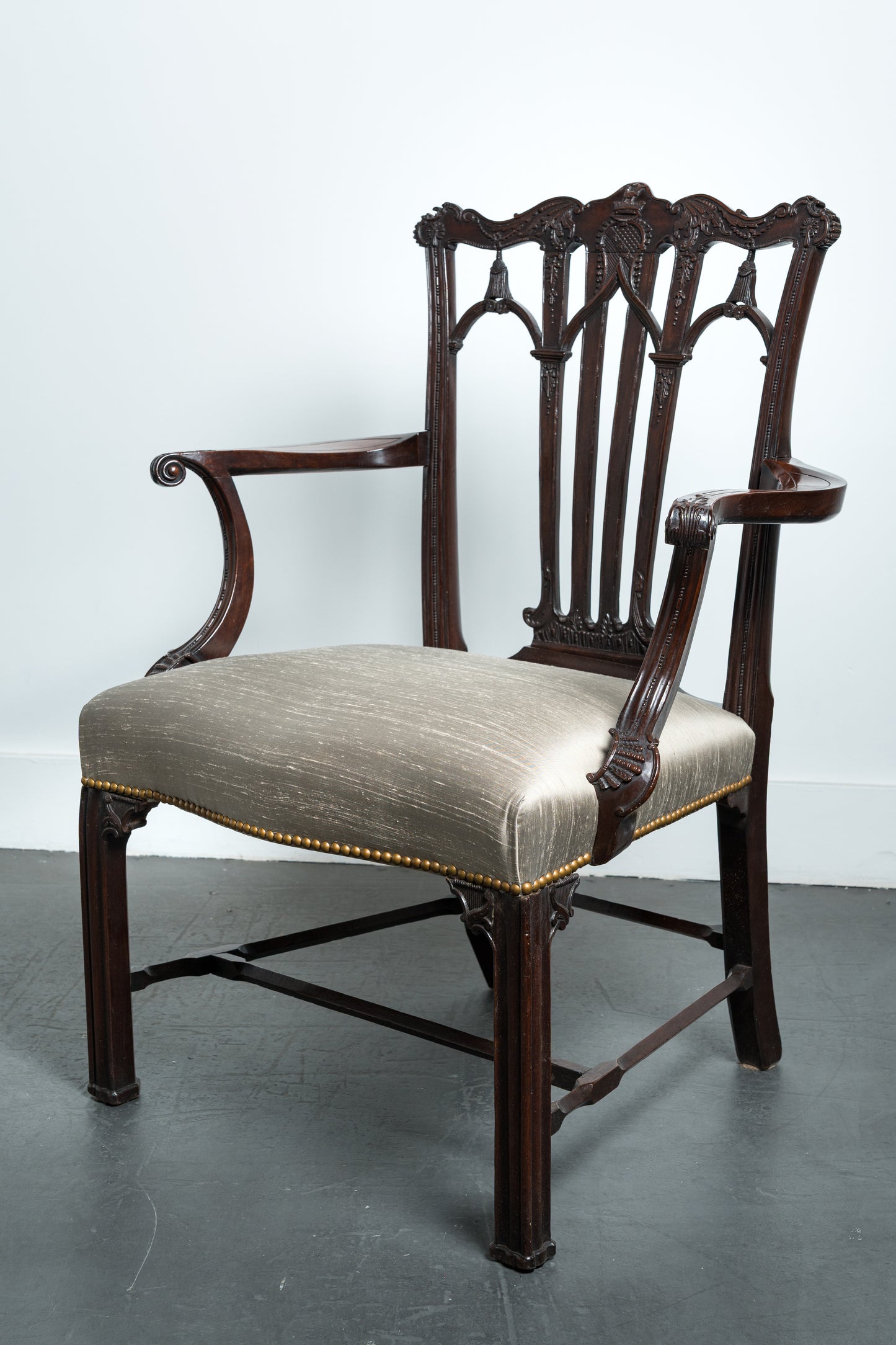 Pair of Mahogany open armchairs with armorial in the crest rail