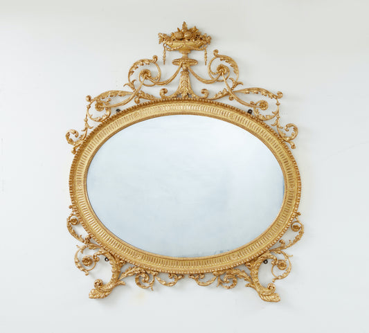 A CARVED AND GILDED NEOCLASSICAL OVERMANTEL LOOKING GLASS circa 1785