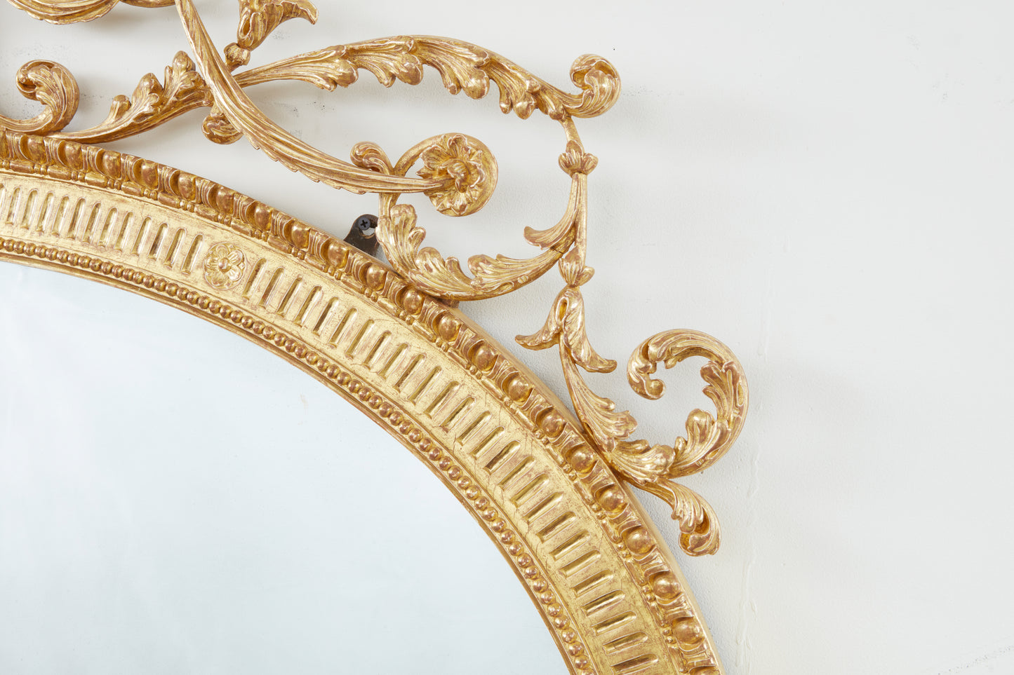 A CARVED AND GILDED NEOCLASSICAL OVERMANTEL LOOKING GLASS circa 1785