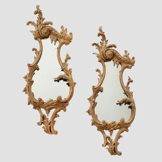 Pair of carved rococo cartouche shaped looking glasses c. 1755