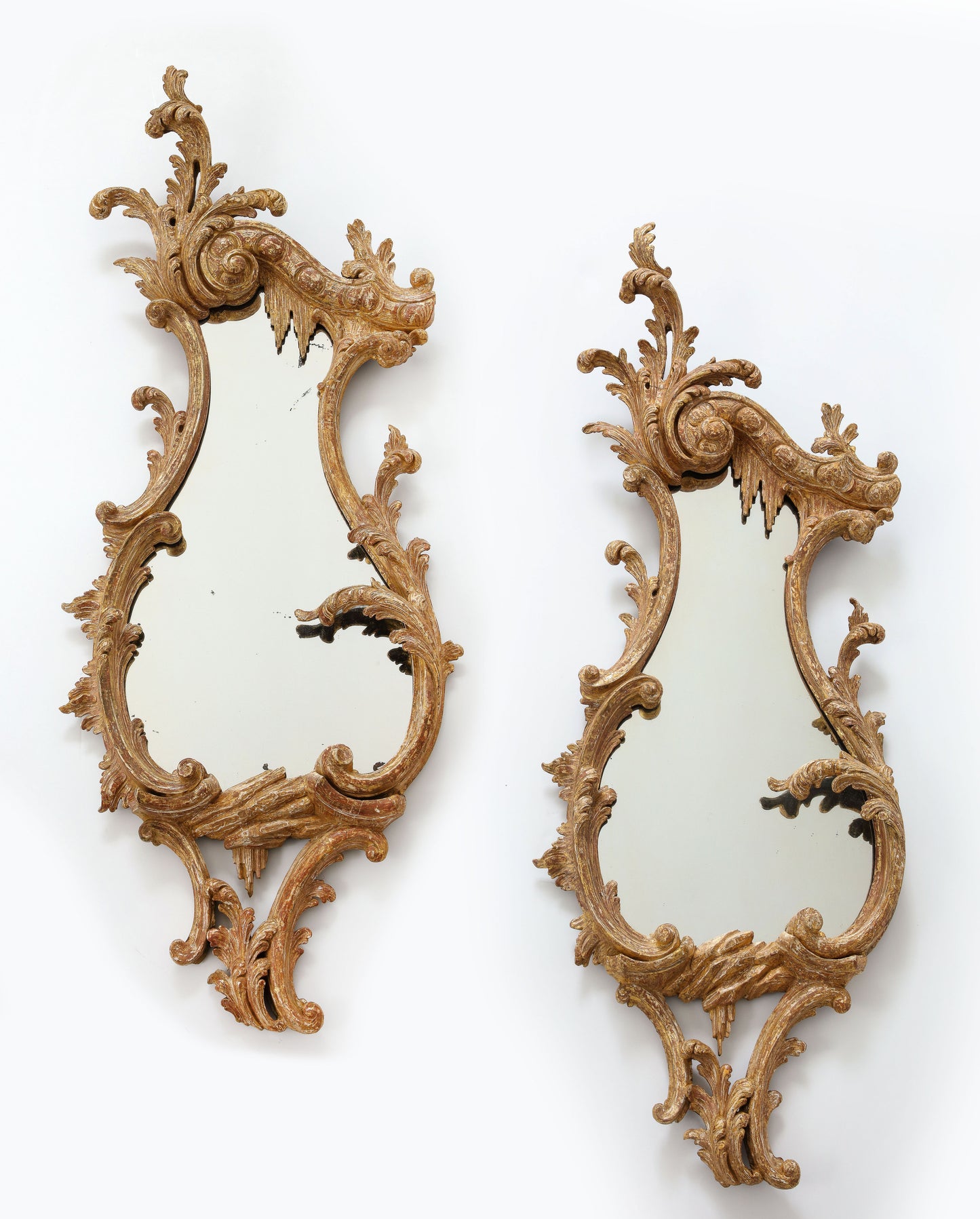 Pair of carved rococo cartouche shaped looking glasses c. 1755