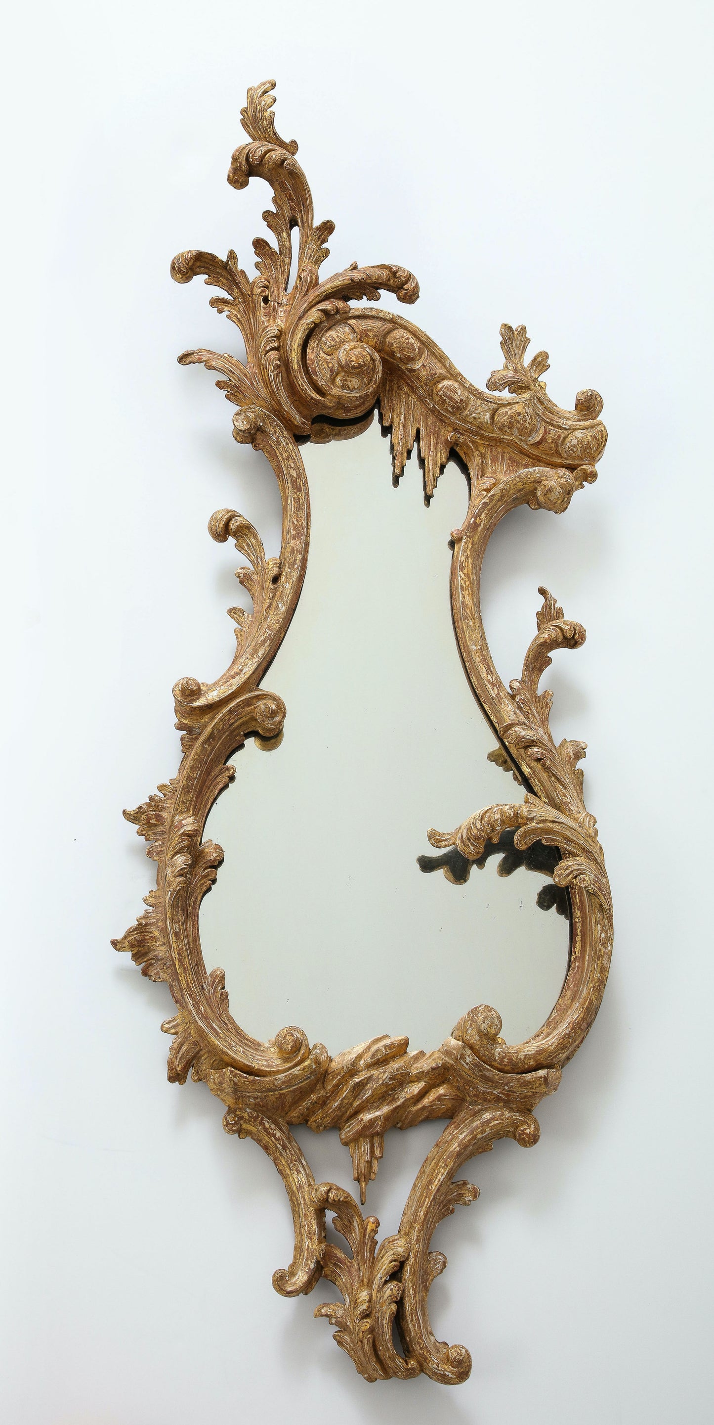 Pair of carved rococo cartouche shaped looking glasses c. 1755