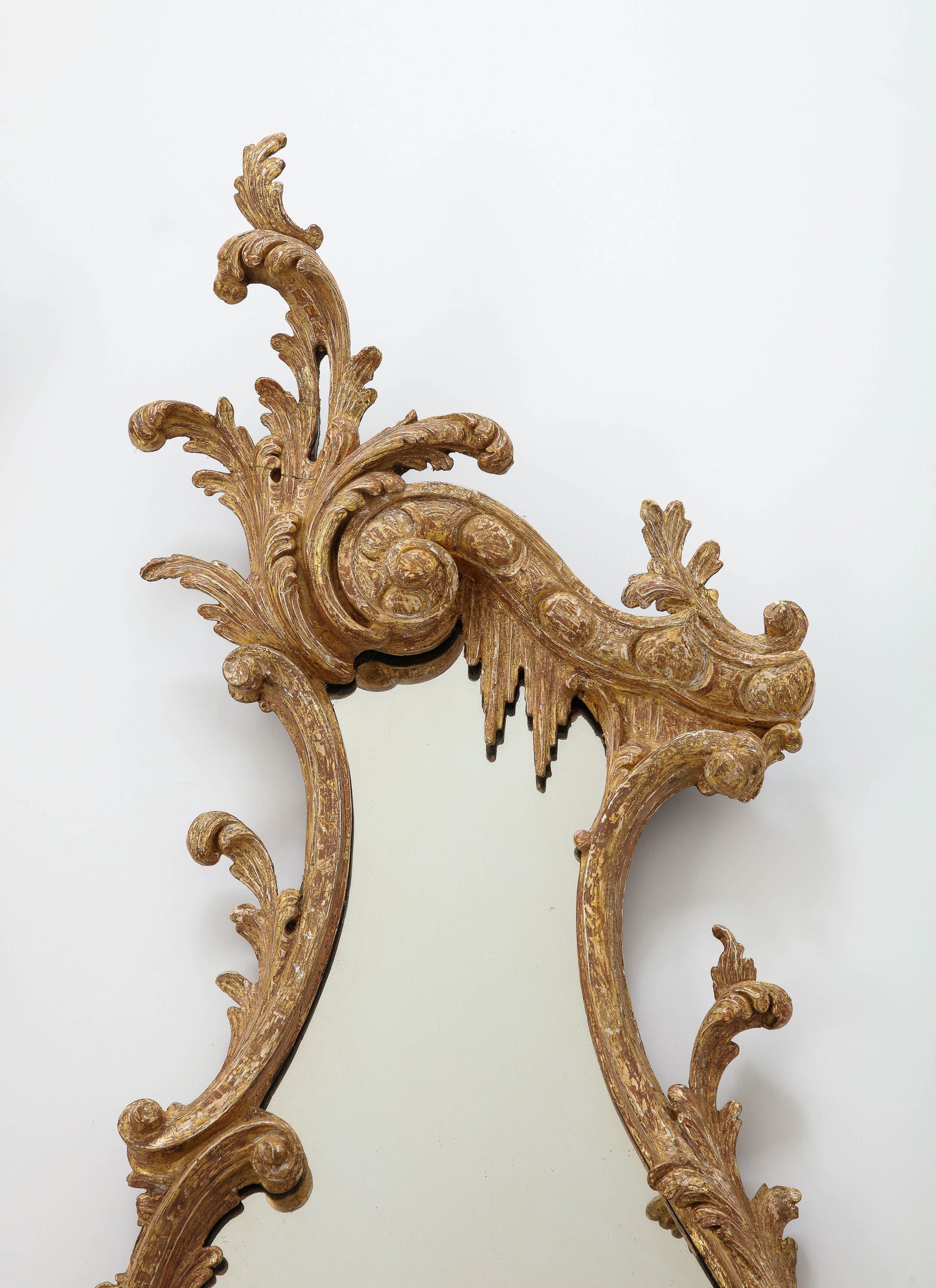 Pair of carved rococo cartouche shaped looking glasses c. 1755