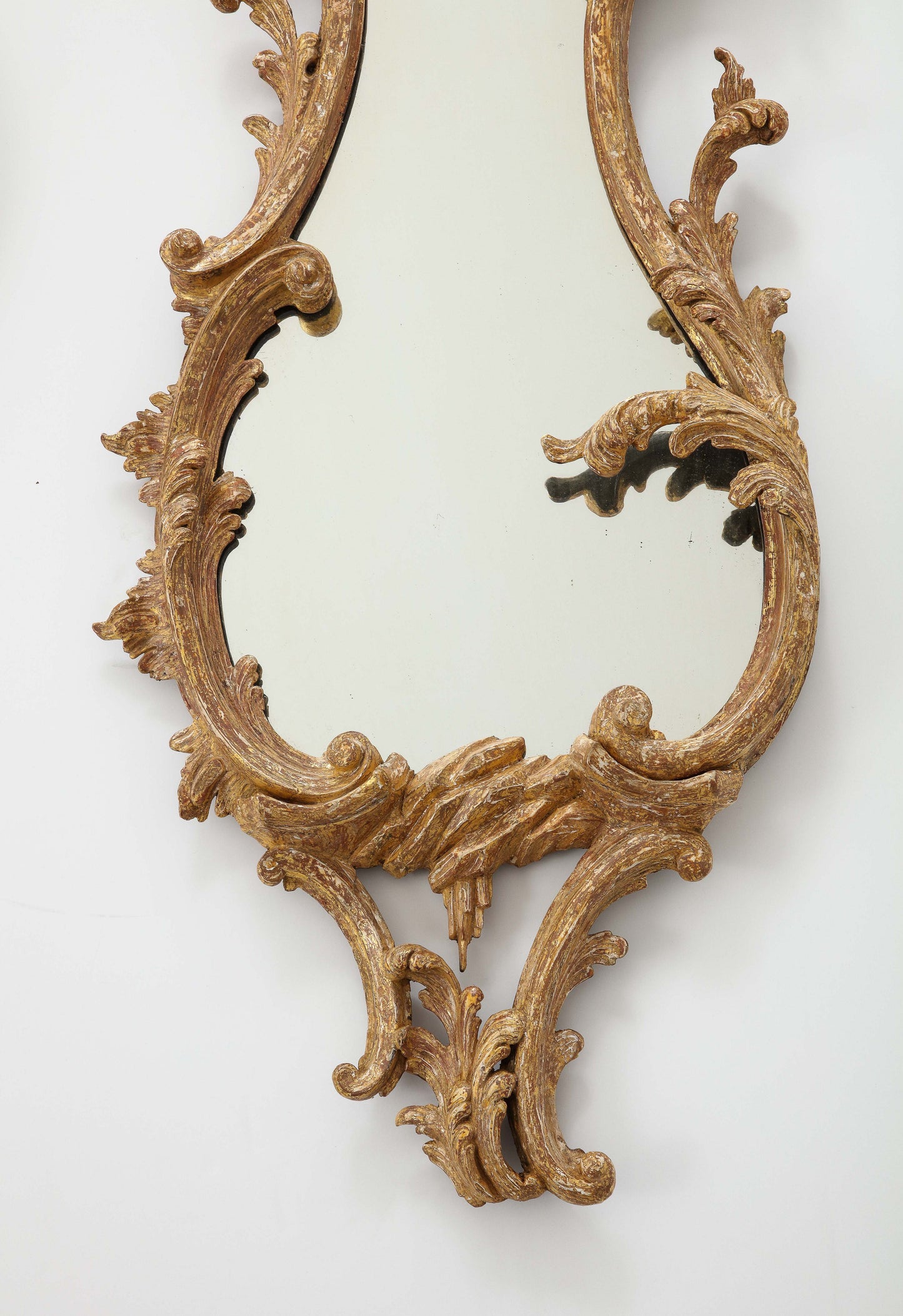 Pair of carved rococo cartouche shaped looking glasses c. 1755